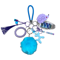 1844505b-c094-4b46-a998-6ac75f70f0e2 blue and purple Keychain with 8 items such as Star Pom-Pom, Moving Beads stick, Pop-it(s), Pea Pod, Texture Tag, Cosmetic(s) (balloon dog, gummy bear. etc), key cap clicker, coil Bracelet, and a leather woven strap