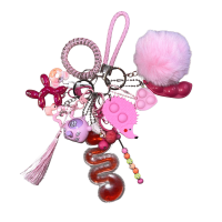 3bdd62c8-4c35-4fc2-89c8-b119859698b0 Keychains with 12 items such as Pom-Pom, Moving Beads stick, Pop-it(s), Pea Pod, Tag with texture sticker, Cosmetic(s) (balloon dog, gummy bear, duck , donut, heart), Tassel, Key Cap Clicker, Paracord, Animal Pop-it, a coil Bracelet, and a leather woven strap
